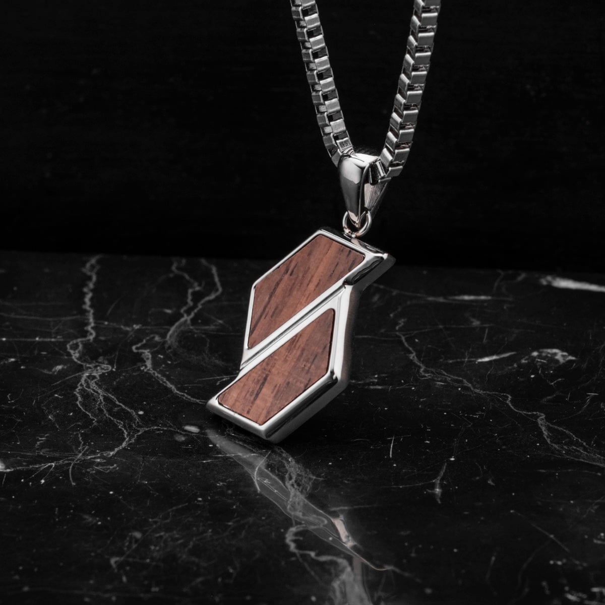 "Baritone Necklaces" necklace featuring a walnut and silver design with a modern, elegant style.