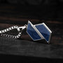 "Baritone Necklaces" necklace features a sodalite stone in a silver setting with a geometric design on a dark background.