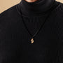 "Baritone Necklaces" necklace featuring a geometric design in zebrawood and black, offering a minimalist and elegant style.