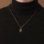 "Baritone Necklaces" necklace featuring a marble and gold pendant with a modern style.