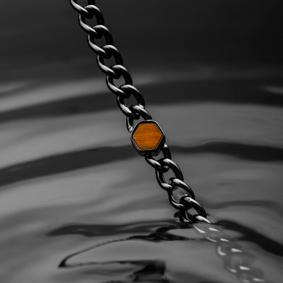 "Bodyguards Necklaces" necklace featuring a Tiger's Eye pendant on a dark gray chain, offering a sleek and stylish design.