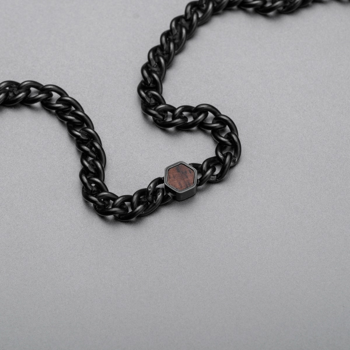 "Bodyguards Necklaces" necklace with walnut and antique silver accents, showcasing a sleek, modern design.