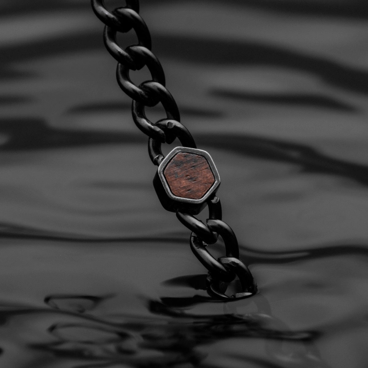 "Bodyguards Necklaces" necklace featuring a walnut and antique silver design with a sleek, modern style.