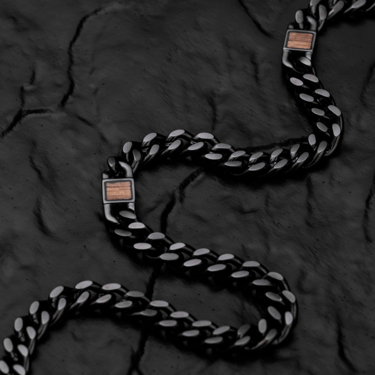 "Bodyguards Strap" chain bracelet featuring a sleek design in walnut and dark gray.