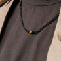 "Bodyguards Necklaces" necklace featuring Tiger's Eye in a dark gray, elegant design.