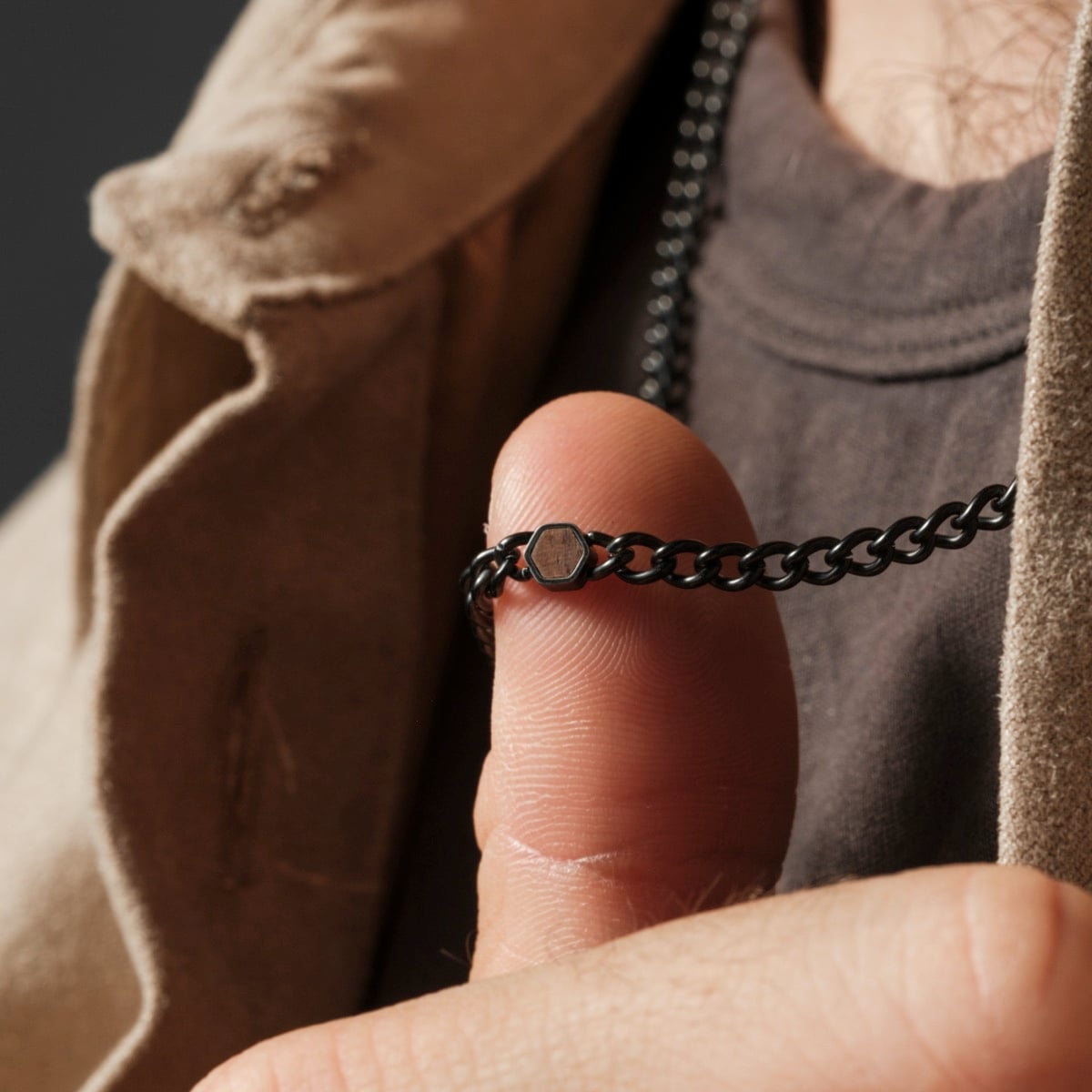 "Bodyguards Necklaces" necklace featuring a walnut and antique silver chain in a rugged, stylish design.