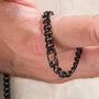 "Bodyguards Necklaces" necklace featuring a sleek walnut and dark gray design.