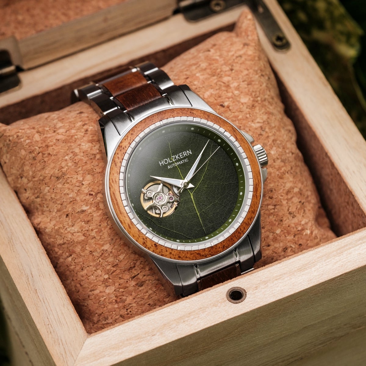 "Whisperwood" watch featuring a koa wood bezel and leaf-patterned dial in an elegant wooden box.