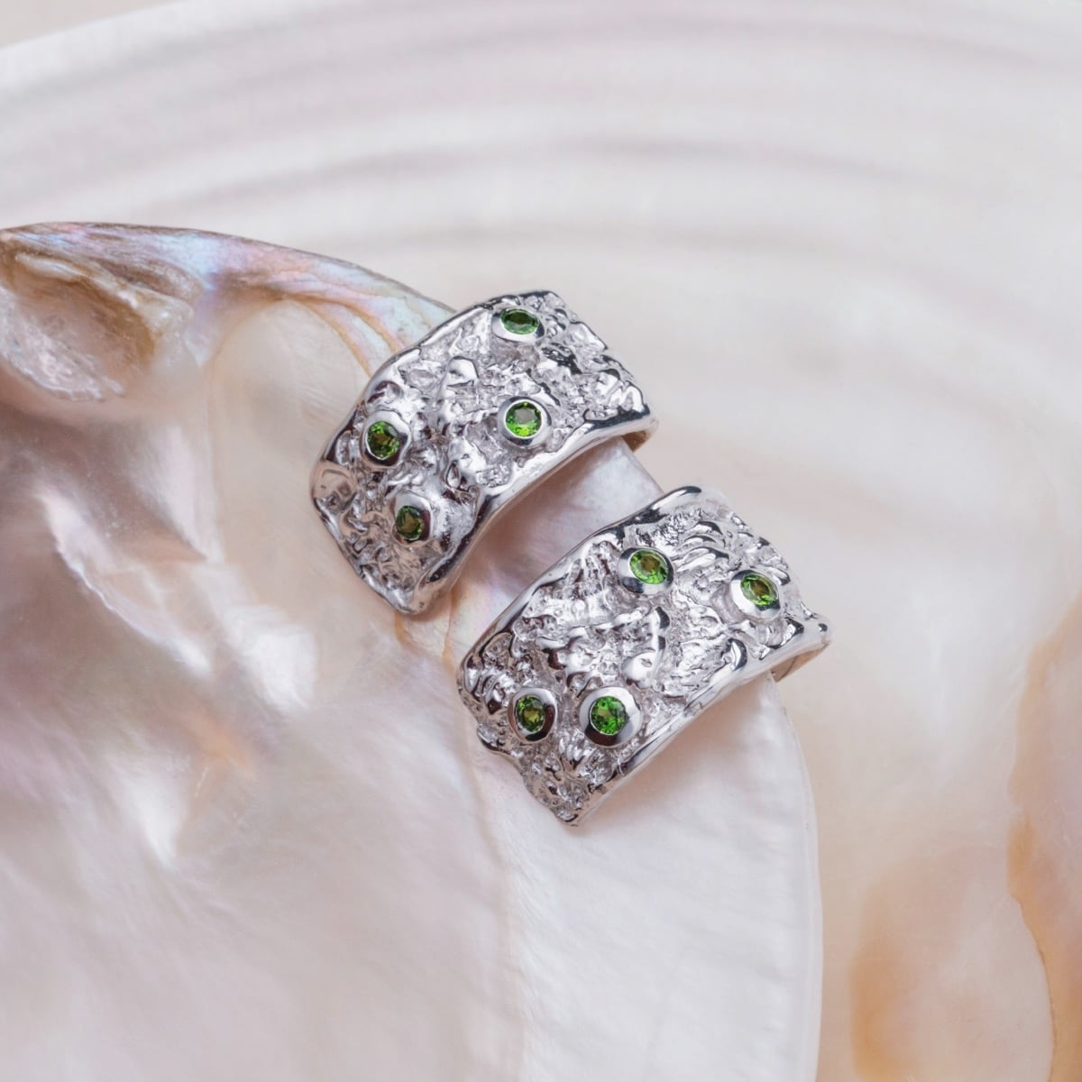Silverstream Earrings - Elegant earrings featuring diopside stones and a textured silver design.