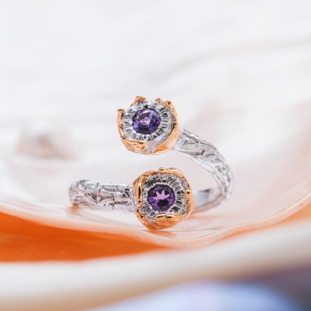 "Silverstream Ring": an elegant amethyst and gold ring featuring a unique, textured design.