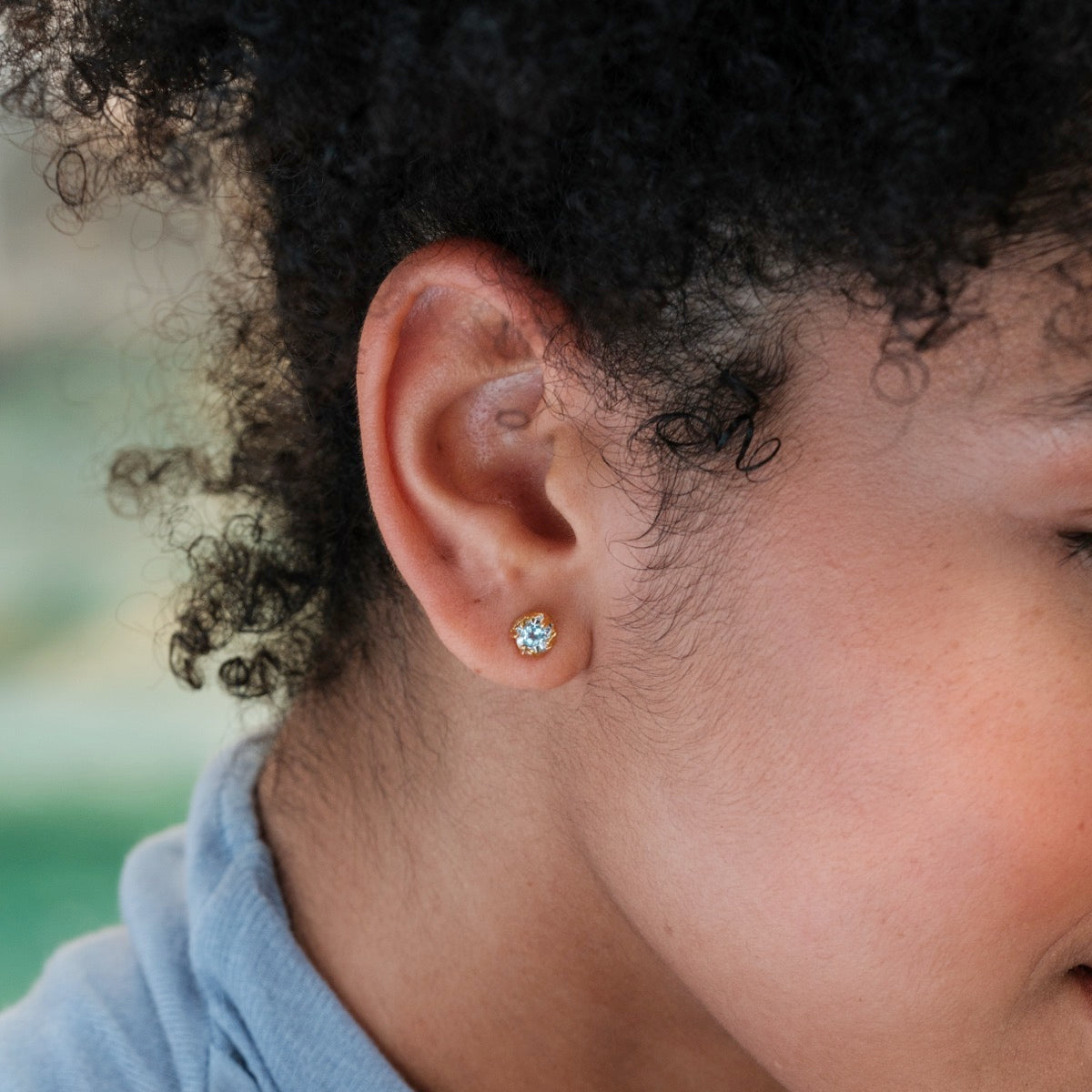 Silverstream Earrings, featuring topaz stones set in gold, showcase a simple and elegant design.