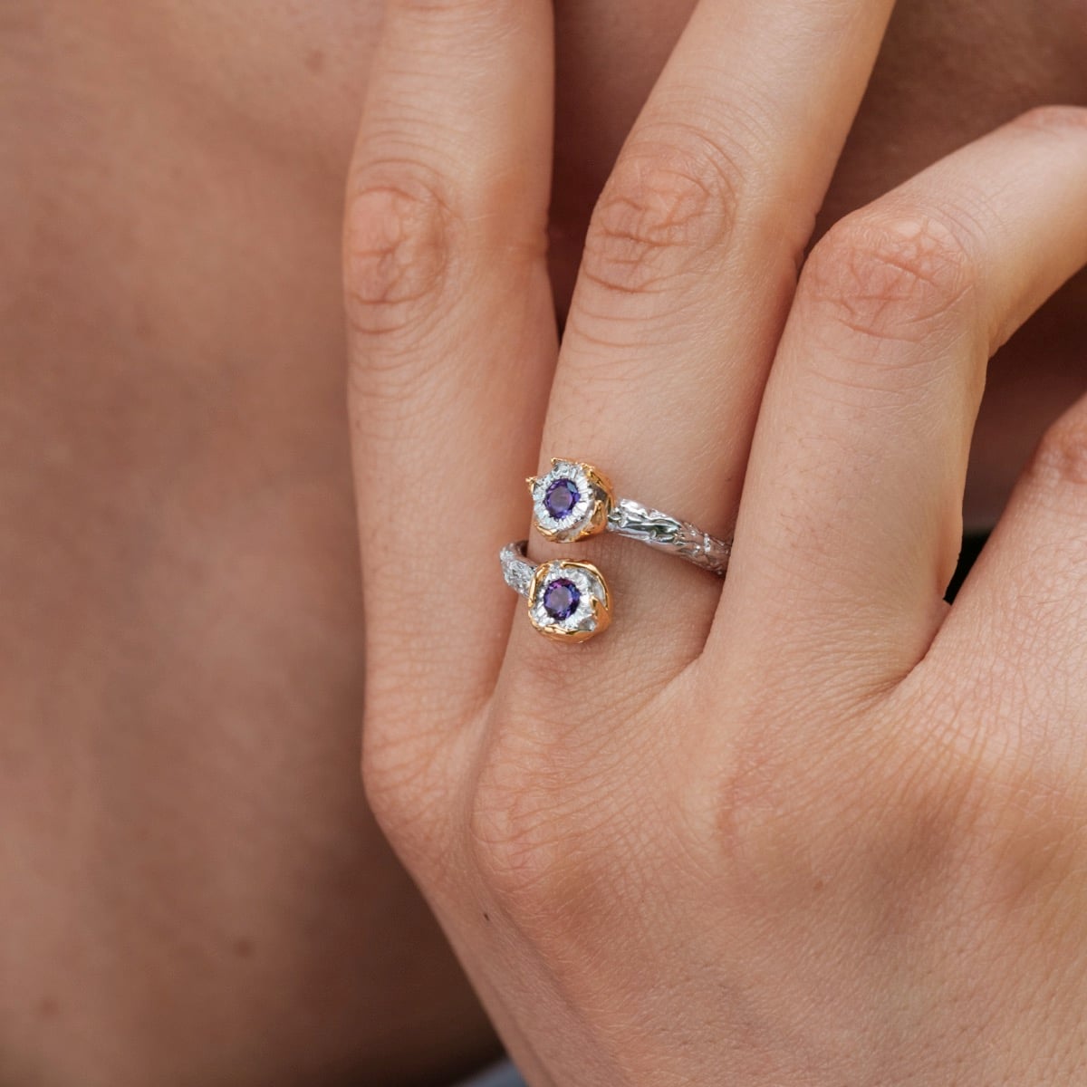 "Silverstream Ring", a gold and amethyst ring with a delicate and elegant design.