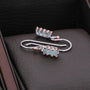 "Silverstream Earrings: Elegant rosegold earrings with aquamarine accents, featuring a modern, sleek design."