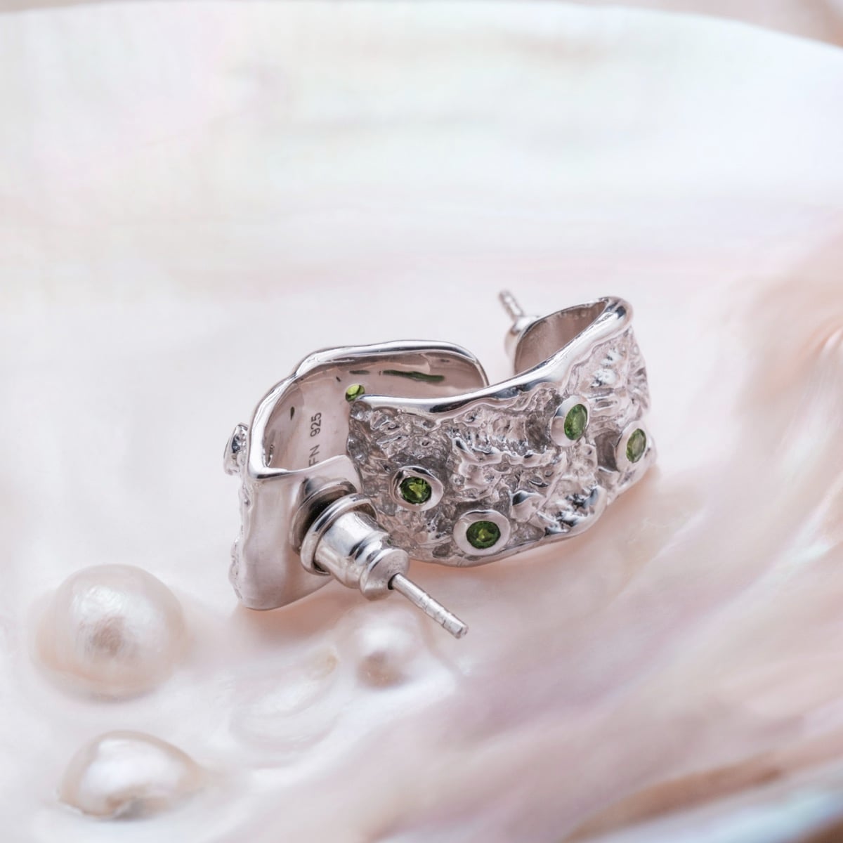 Silverstream earrings feature a textured silver design with vibrant diopside accents.