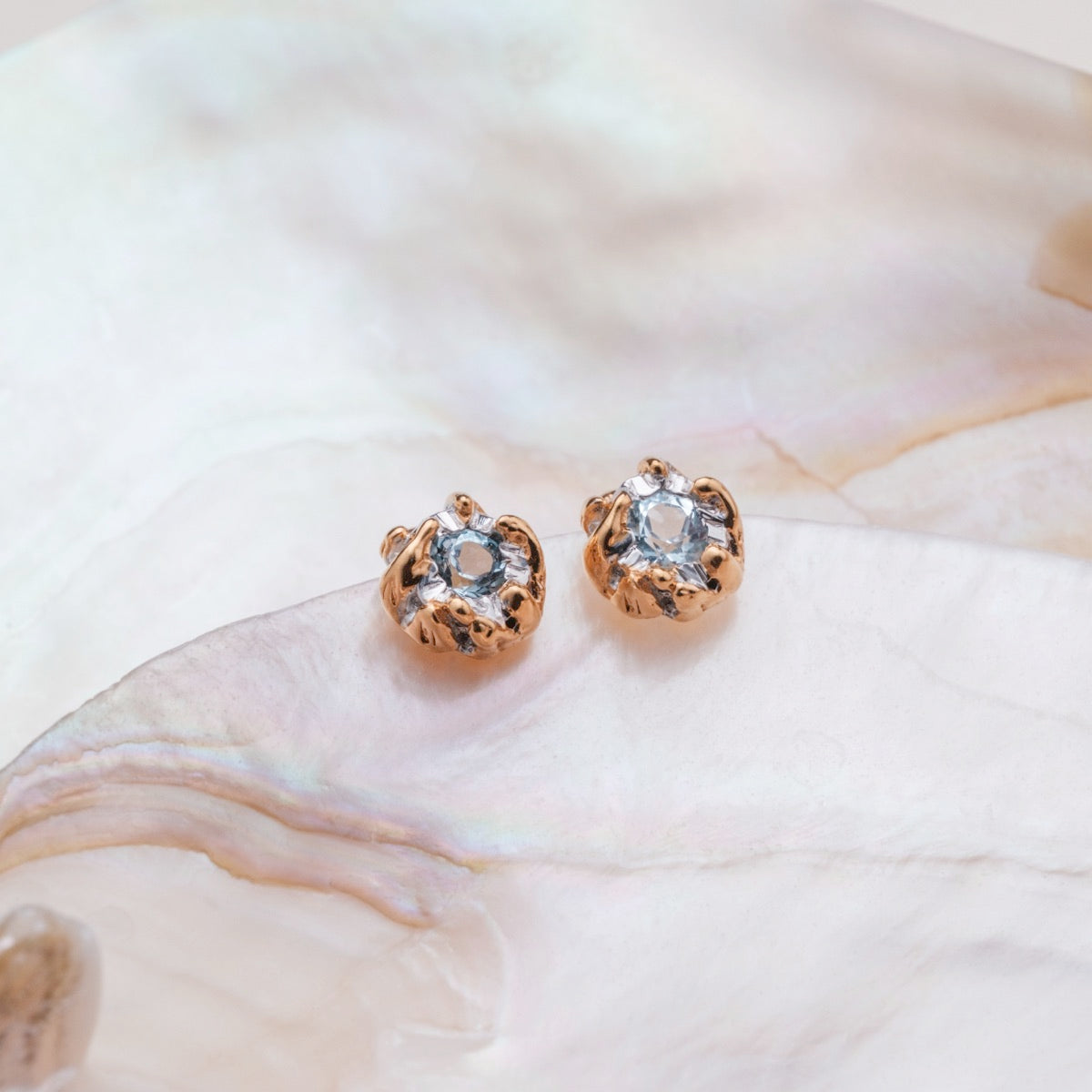 "Silverstream Earrings", elegant earrings featuring topaz stones in a gold setting, exuding a sophisticated and stylish allure.