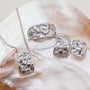 Silverstream earrings, featuring silver with diopside accents, showcasing a textured and elegant design.
