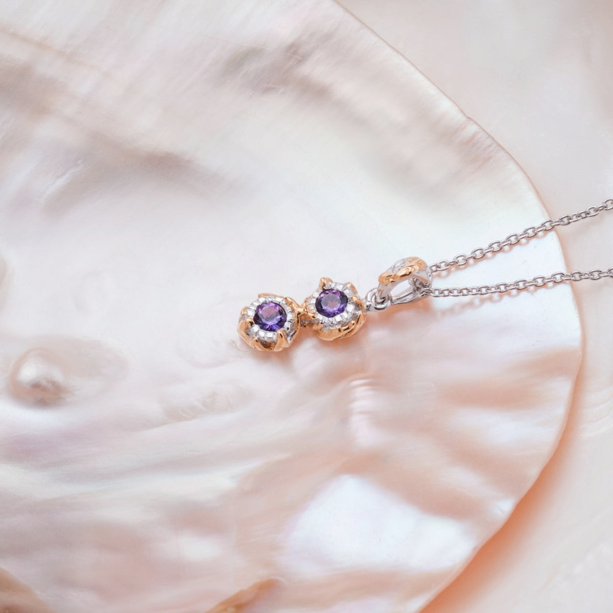 "Silverstream Necklace": Elegant necklace with amethyst and gold accents, featuring a delicate and refined design.