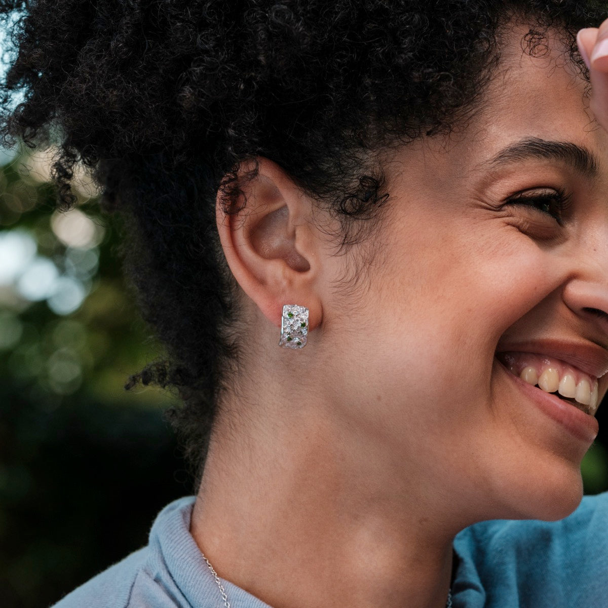 Silverstream earrings feature a sleek silver design with diopside accents for an elegant look.