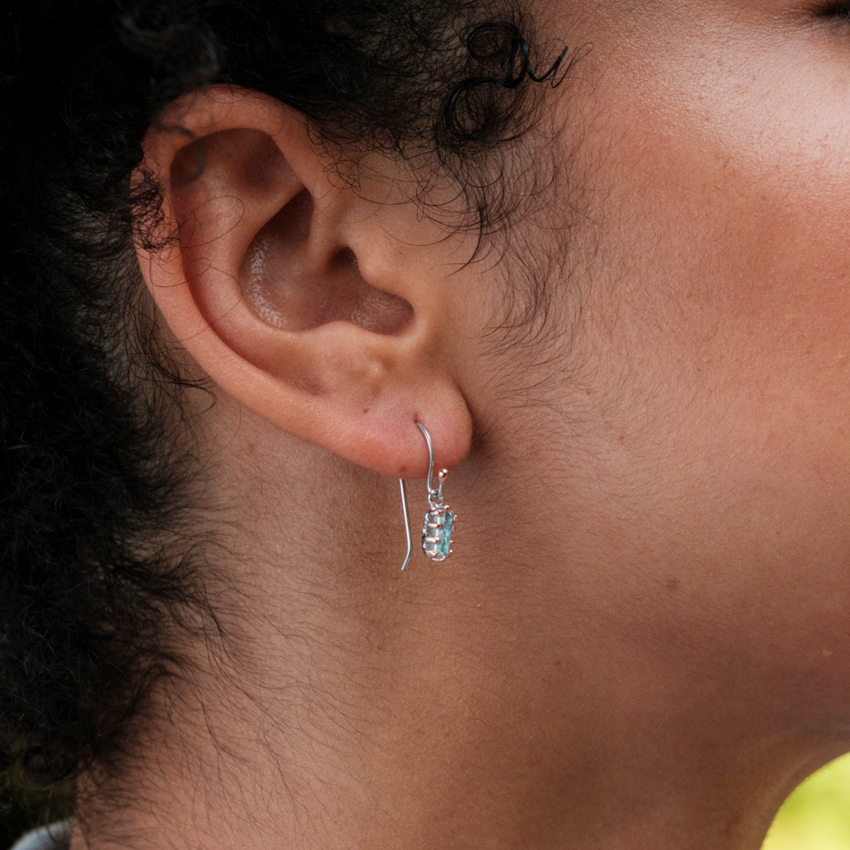 "Silverstream Earrings, elegant earrings featuring aquamarine stones and rosegold accents, offering a sophisticated and stylish look."