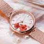 "Everbloom" watch in a plum blossom and rose gold design with intricate floral details on the dial.