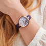 "Everbloom", elegant watch featuring floral design with plum blossom and violet accents on wrist.