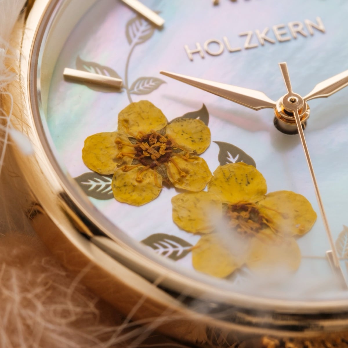 "Everbloom" watch featuring a gold-tone case and plum blossom design on the dial for an elegant look.