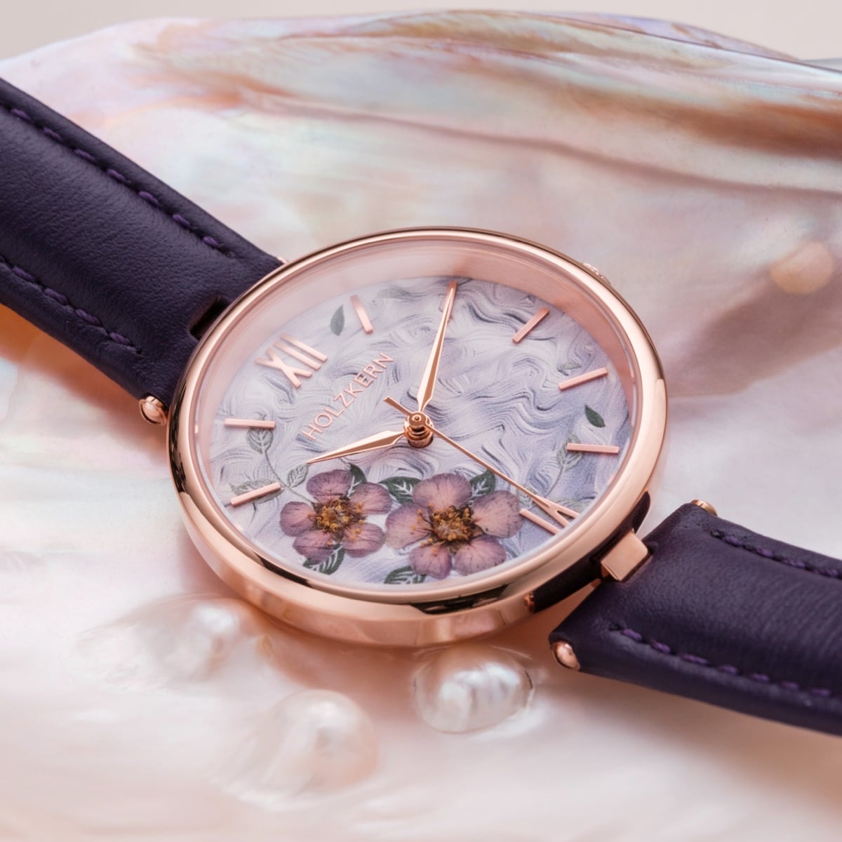 "Everbloom" watch featuring a floral design with a plum blossom motif and violet leather strap.