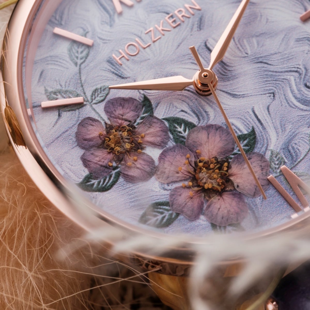 "Everbloom" watch with floral motif and elegant violet tones.