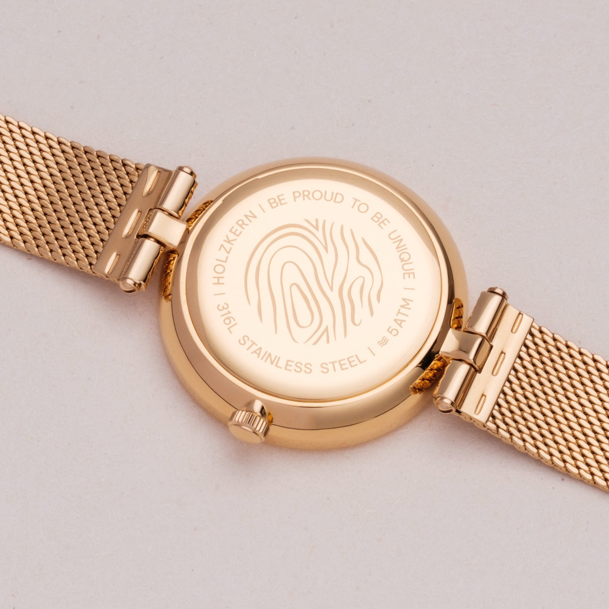 "Everbloom" watch with plum blossom and gold tones, featuring a sleek, modern design.