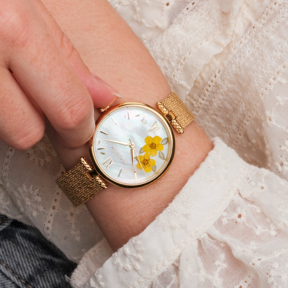 "Everbloom" watch featuring a delicate gold band and elegant floral accents on the dial.