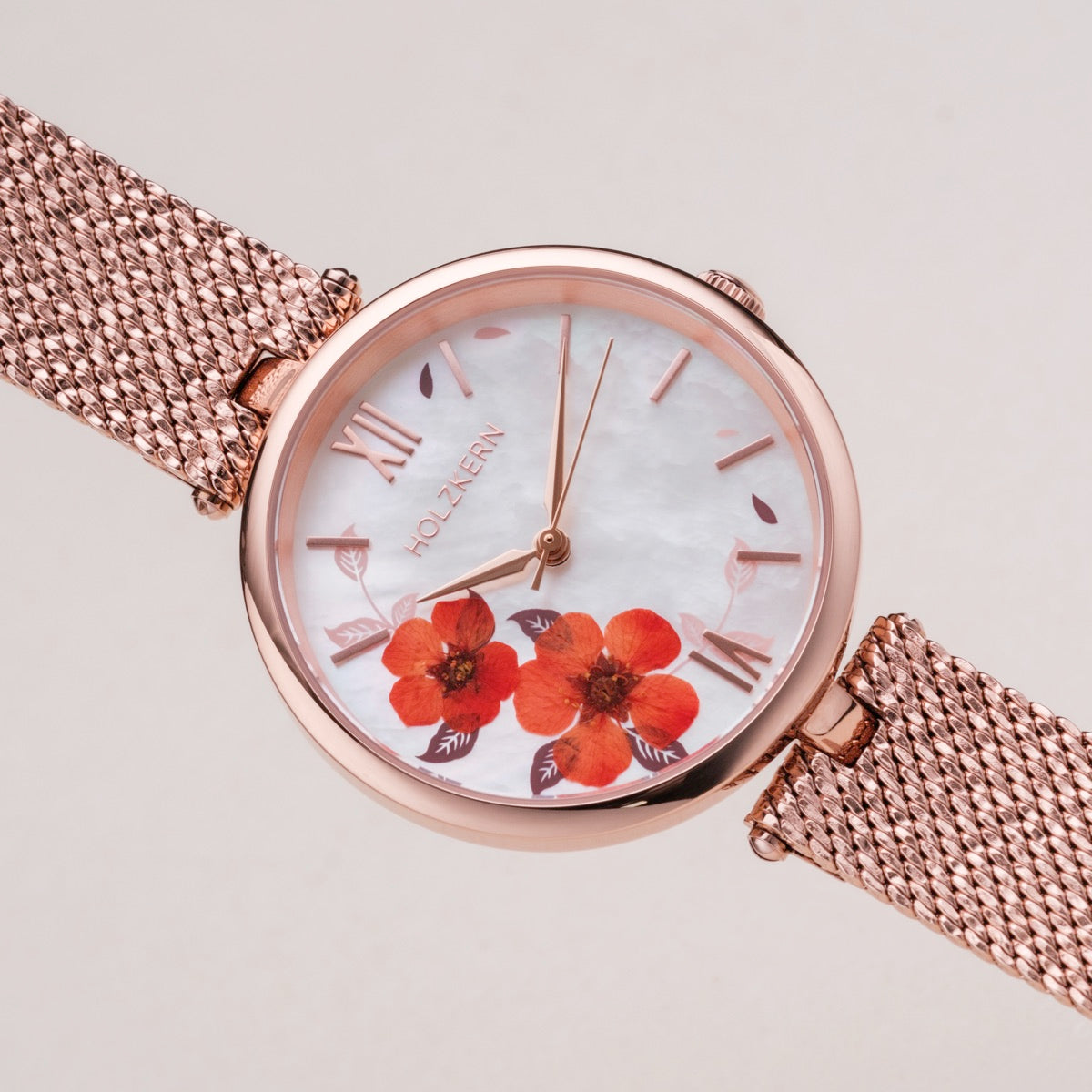 "Everbloom" watch with plum blossom design and rose gold mesh strap.
