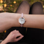 "Alva" watch with a marble face and rose gold accents, featuring a sleek leather strap.