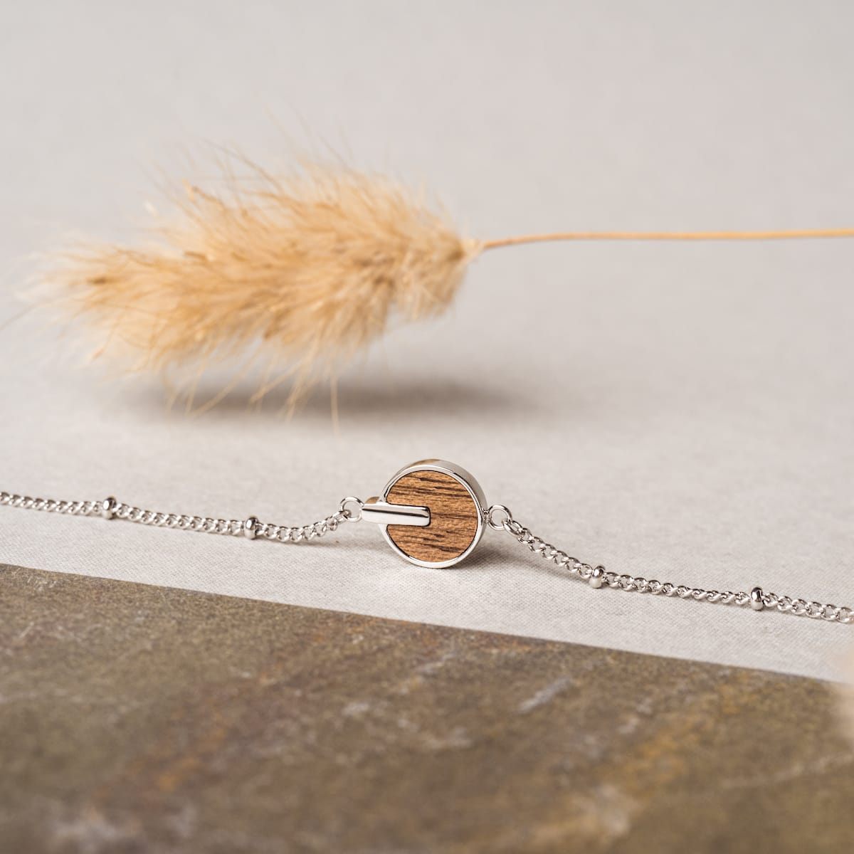 "Opacity Bracelet" bracelet featuring a walnut and silver design with a modern, minimalistic style.