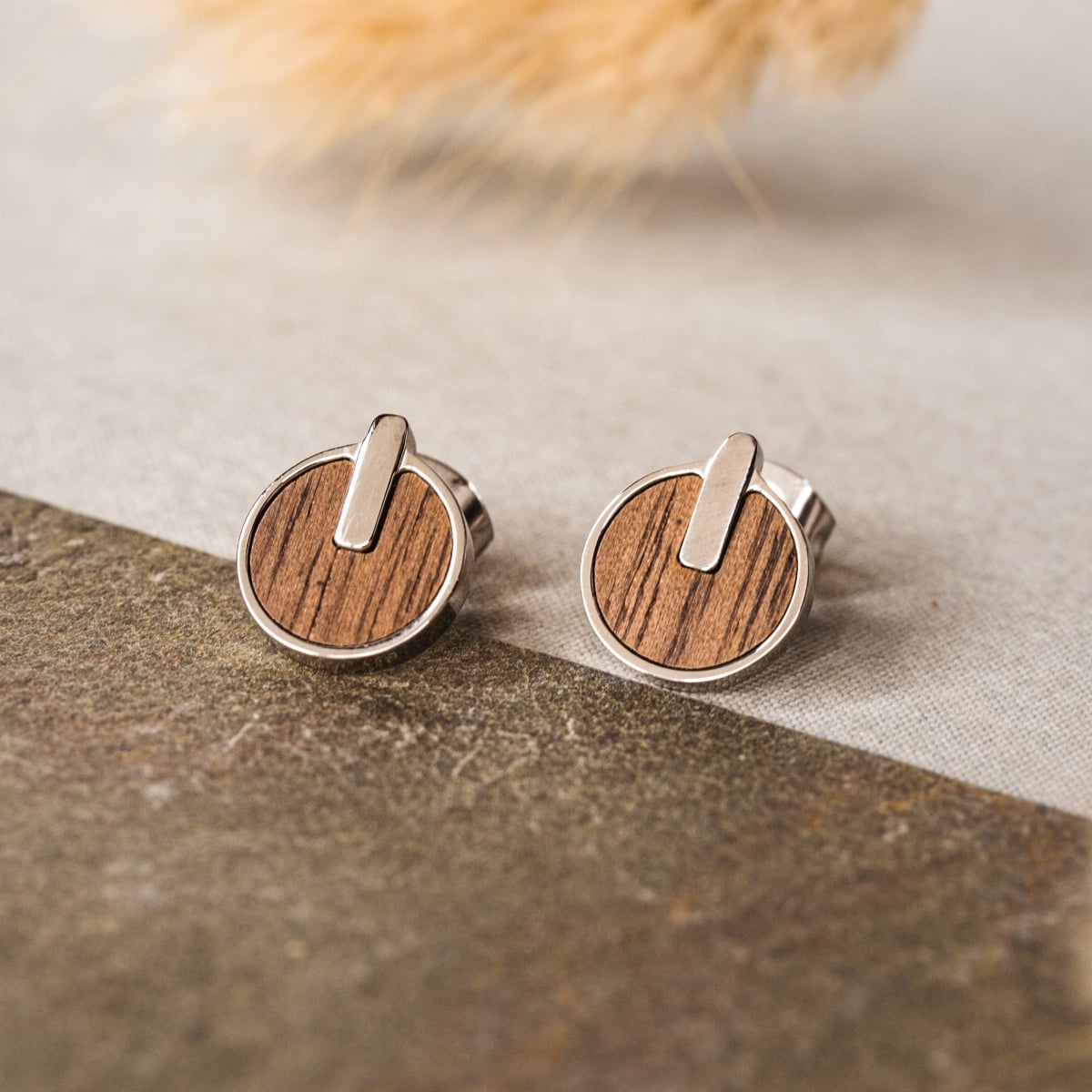 Opacity Earrings: Walnut and silver earrings with a modern round design.
