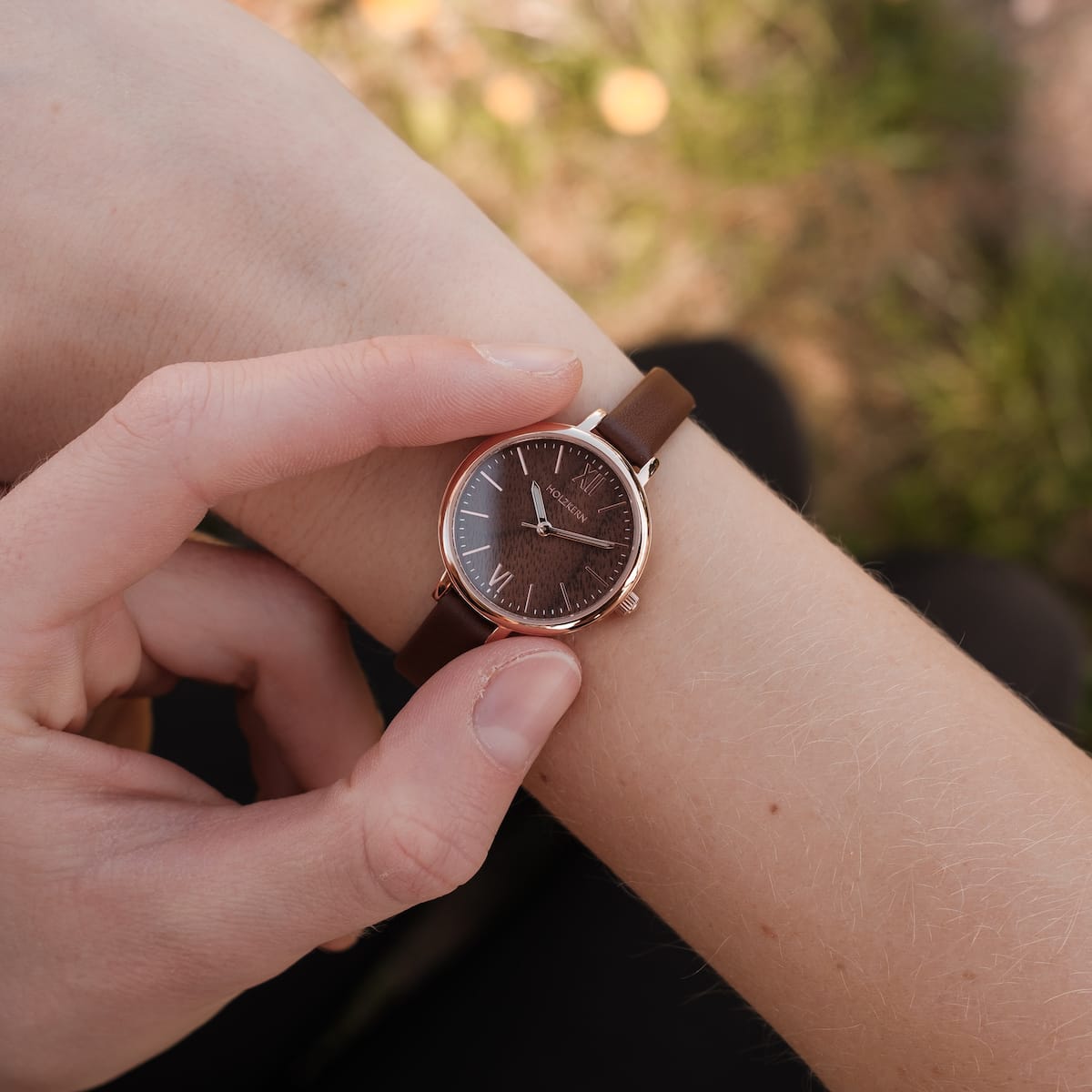 "Shirin" watch featuring a walnut dial and rose gold accents with a sophisticated, minimalist design.