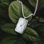 "Aquarell Necklace" necklace features a geometric silver design with white nacre accents, offering an elegant and modern aesthetic.