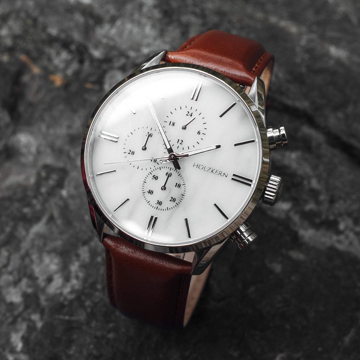 "Melodical" watch featuring a marble dial and silver accents with a sleek, modern design.