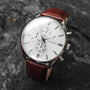 "Melodical" watch featuring a marble dial and silver accents with a sleek, modern design.