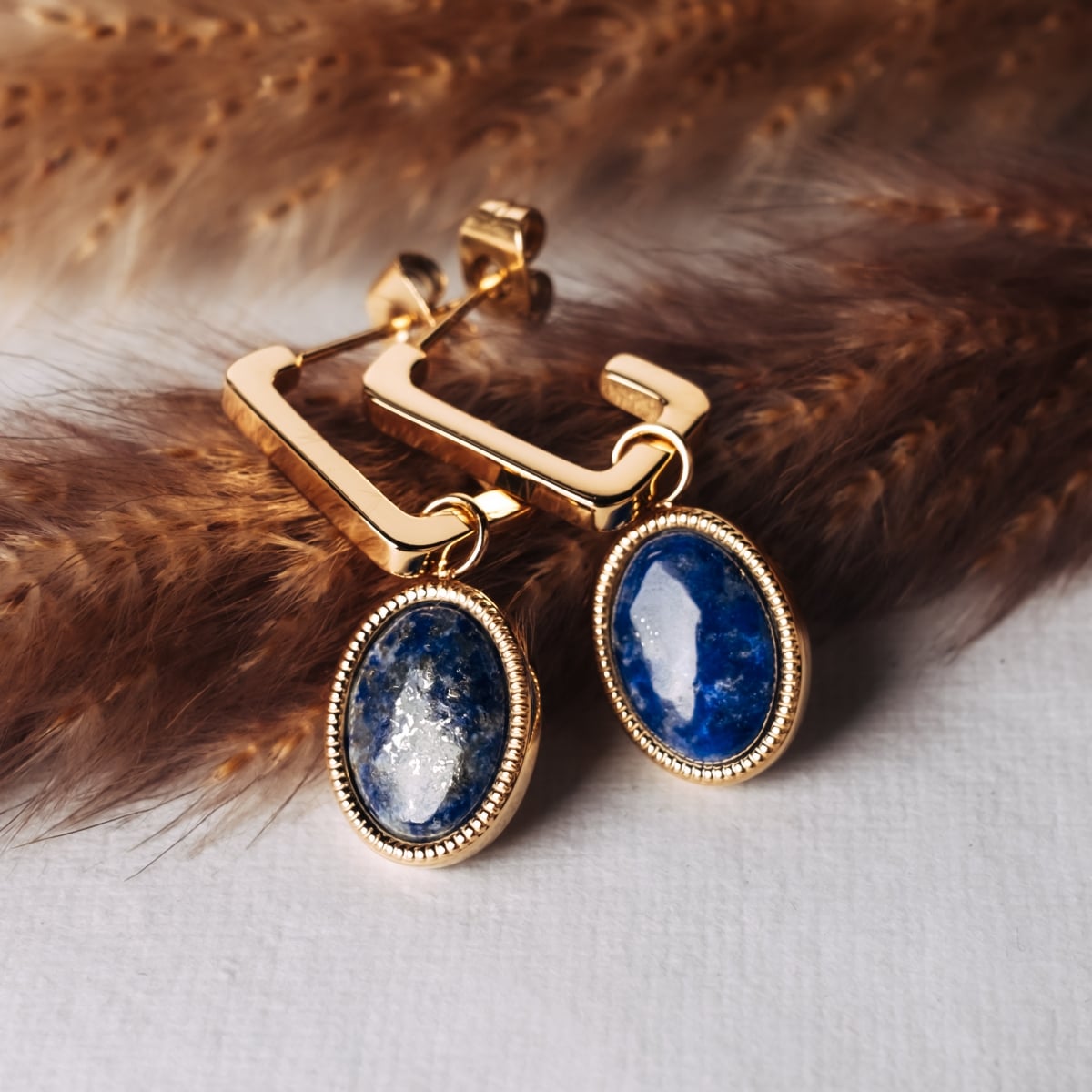Mirror earrings, featuring a modern design with lapis lazuli and gold accents.