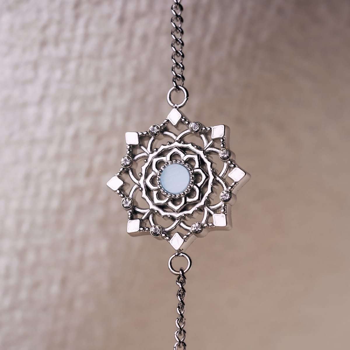 "Aphonia Bracelet" bracelet featuring intricate silver design with aquamarine accents, showcasing a delicate and elegant style.