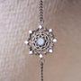 "Aphonia Bracelet" bracelet featuring intricate silver design with aquamarine accents, showcasing a delicate and elegant style.