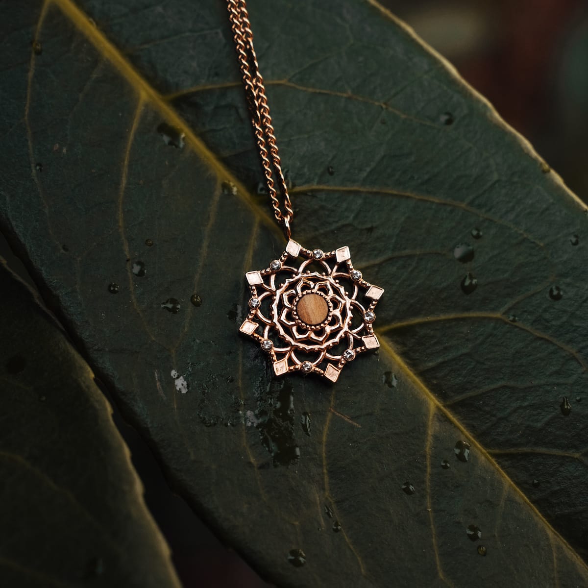 "Aphonia Necklace" necklace in a rose gold finish, featuring an intricate olive green design.