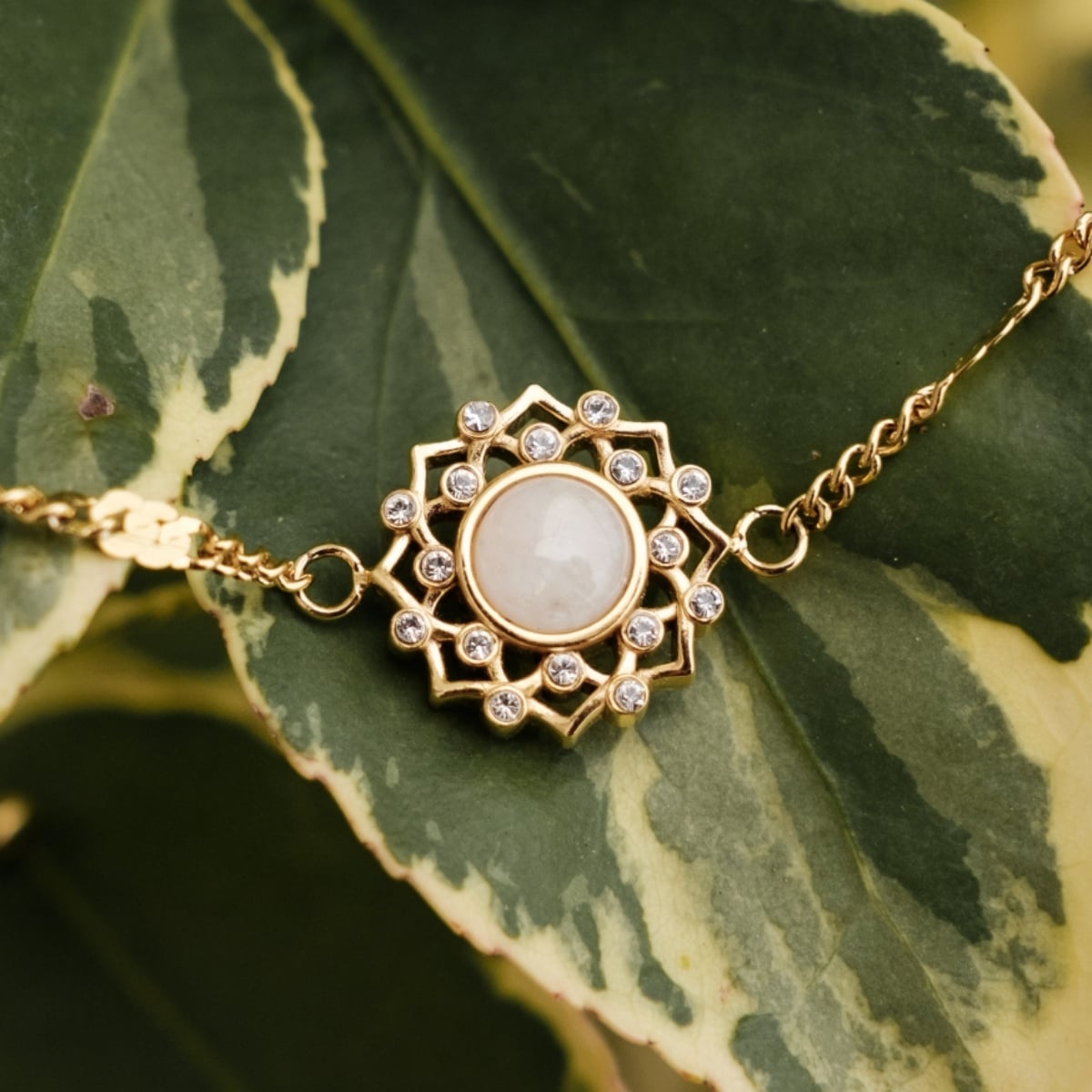 "Composition Gem Bracelet" bracelet featuring moonstone and gold, styled with a delicate and intricate design.