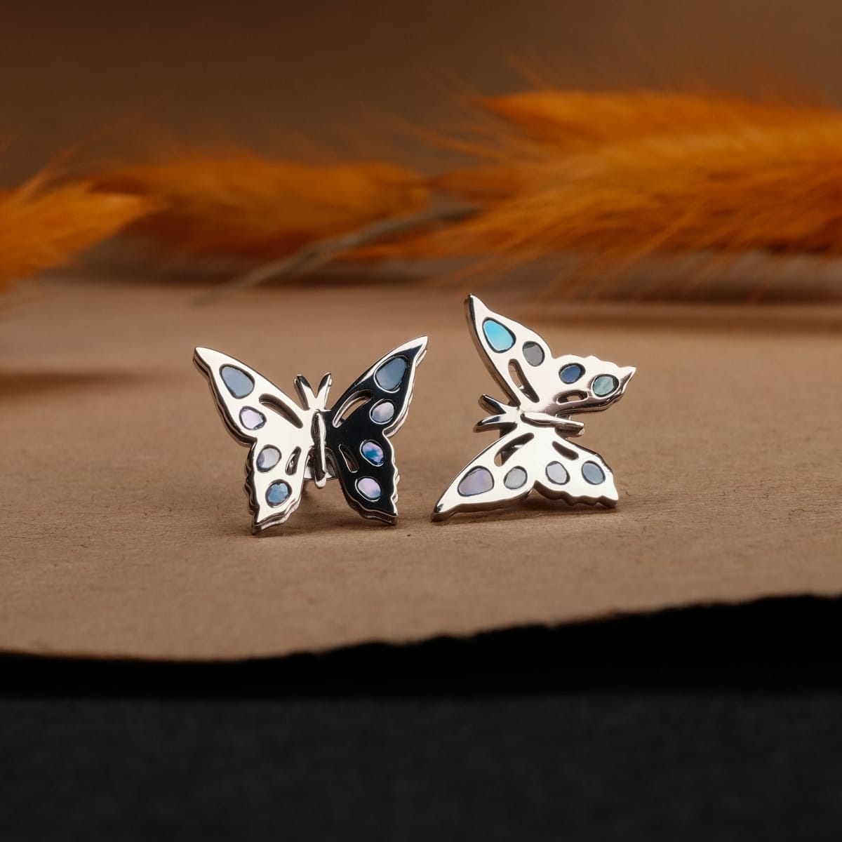 "Fritillary earrings", butterfly-shaped earrings in nacre and silver, featuring a delicate iridescent design.