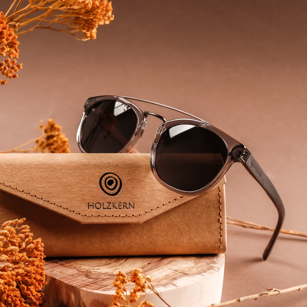 "The Trustworthy" sunglasses, featuring a sleek design with Leadwood and Ash elements, set against a warm, earthy background.