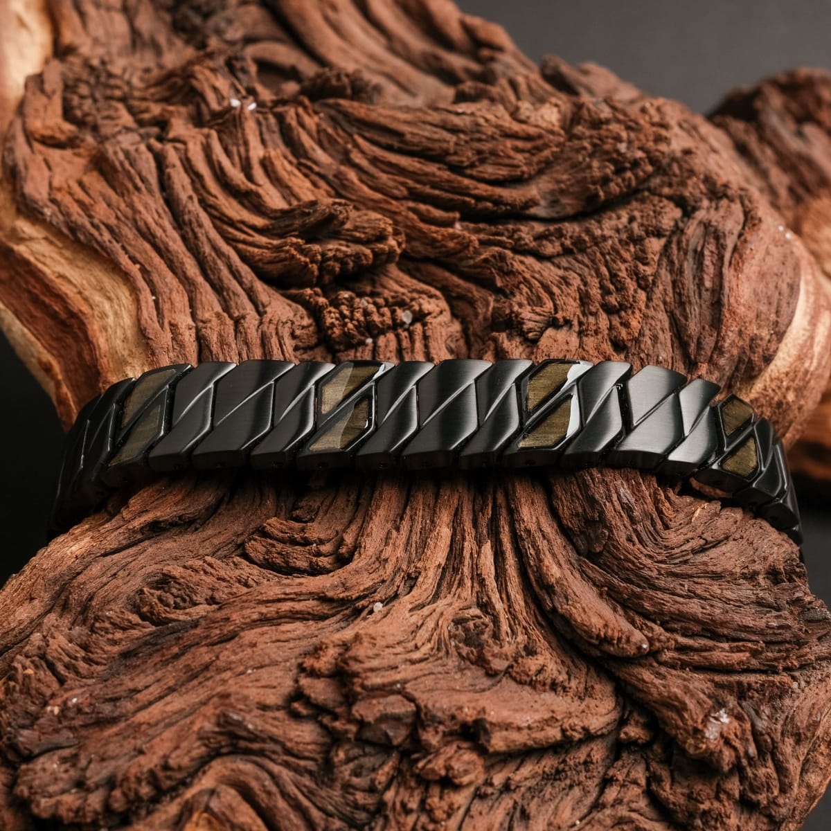 "Baritone" bracelet featuring a sleek maple and black design on rustic wood background.