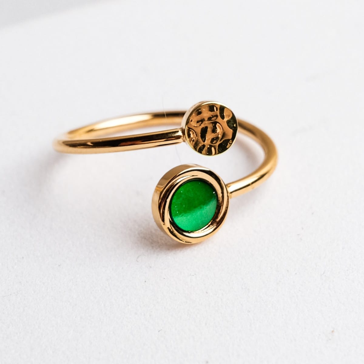 "Zendala Ring": Elegant gold ring with a vibrant green nacre accent, showcasing a modern, chic design.