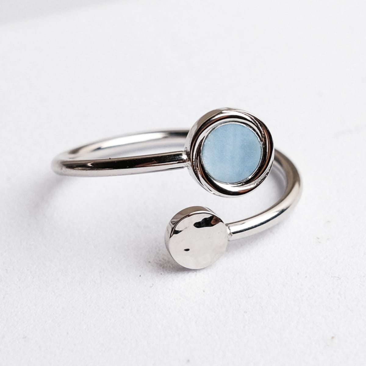 "Zendala Ring", a stylish ring, features a sleek silver band with a nacre accent for an elegant touch.