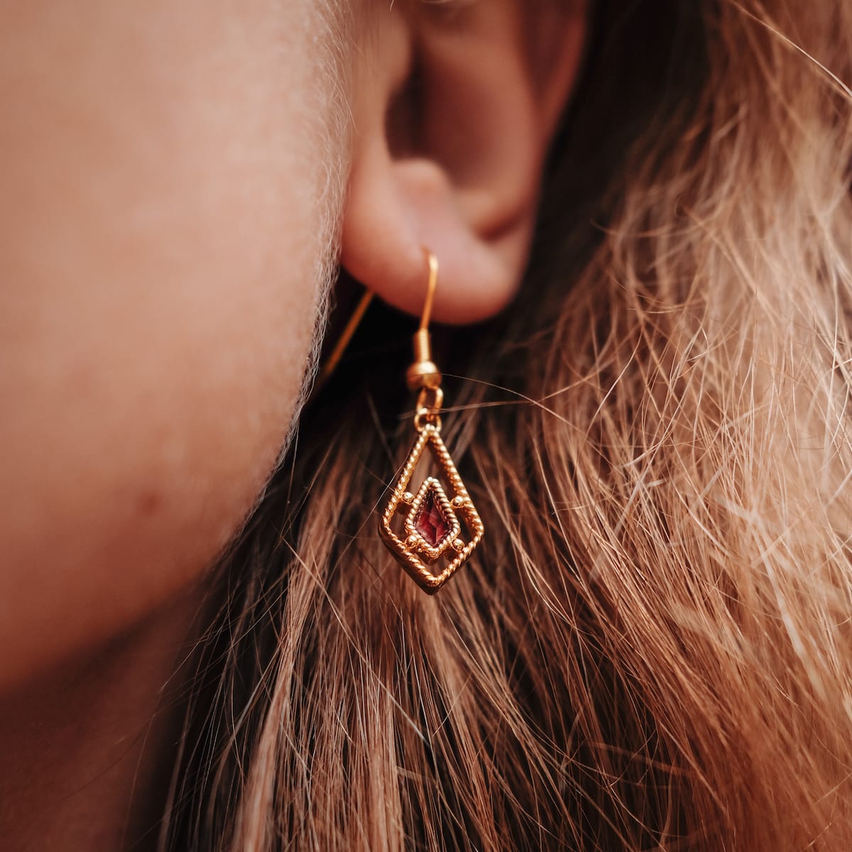 Daydreamer Earrings - Elegant gold earrings featuring amethyst accents in a delicate, geometric design.