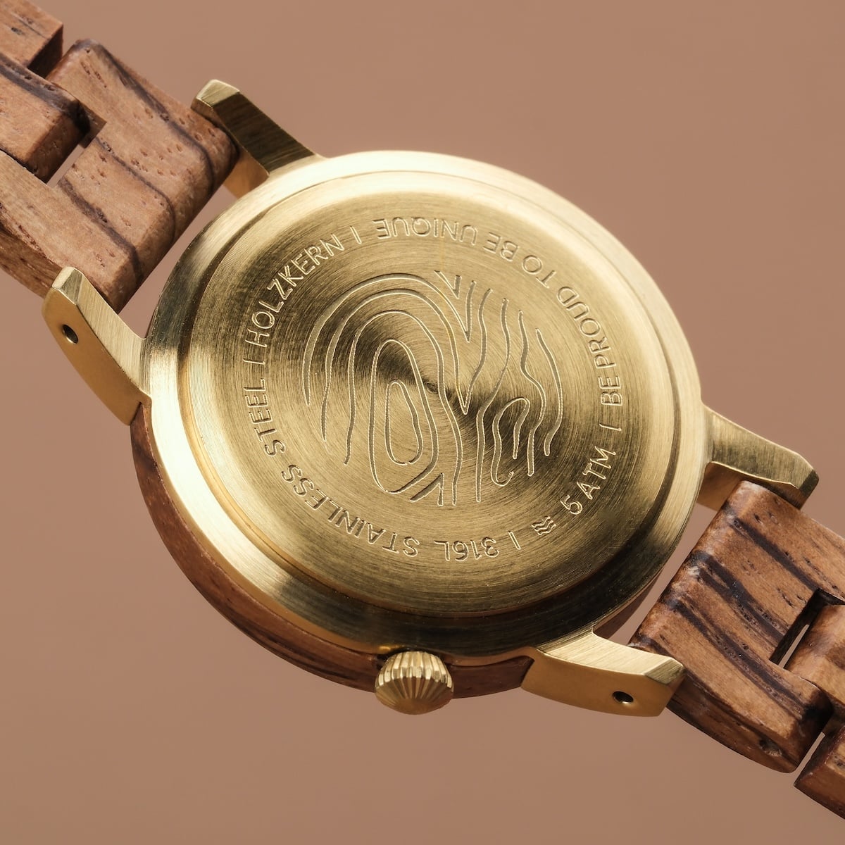 "Balos" wristwatch showcasing a zebrawood band and a marble-accented brass case in a natural, elegant style.